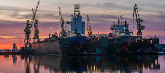 Wall Mural - Ship repair at the ship repair yard during a spectacular sunrise-panorama