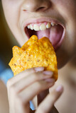 Fototapeta  - Anonymous girl about to eat spicy tortilla chips at home