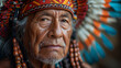 An Indian in the traditional face coloring of red Indians and wearing a headdress.