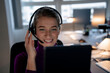 © Westend61 - Happy customer service representative wearing headset and talking in office