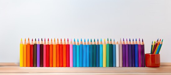 Poster - Vibrant Colored Pencils Arranged on Wooden Table Ready for Creative Artwork