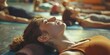 © Fotograf - A group of people laying on top of a yoga mat. Perfect for health and fitness concepts