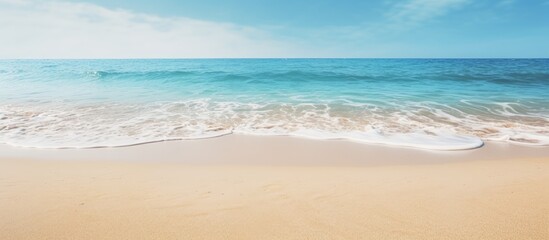 Poster - Tranquil Seaside Scene: Sun-Kissed Sandy Beach Embraces Gentle Wave Under Clear Skies