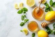 Composition with lemons, mint, ginger, honey in glass jar and honey wooden dippers top view. Food for immunity stimulation and against seasonal flu. Healthy natural remedies to boost immune system. 