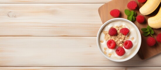 Wall Mural - Nutritious Breakfast Spread: Oatmeal, Yogurt, Raspberries, and Banana on Wooden Table