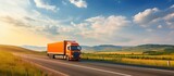 Fototapeta Zachód słońca - Vibrant Harvest: Truck Carrying Grain on Rural Highway amid Bountiful Fields