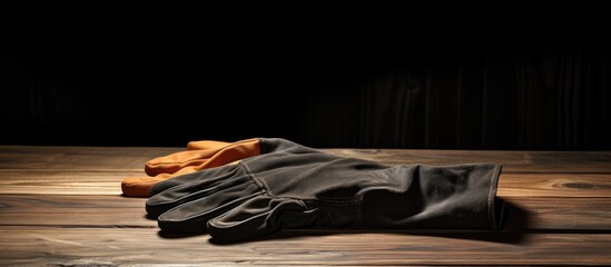 Poster - Protective Work Gloves Placed Carefully on Rustic Wooden Table, Ready for Use