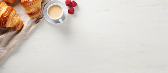 Poster - An Elegant Breakfast Setting with Fresh Croissants and Steaming Coffee on White Tablecloth