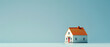 minimalistic Miniature house on light Blue background, building savings advertising