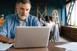 © opolja - Mature man working in office