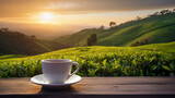 Fototapeta  - A white cup of tea on the wooden table with tea plantation background at beautiful sunrise