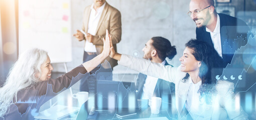 Poster - Energetic business team celebrating a success with a high-five in a collaborative office setting