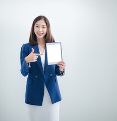 Wall Mural - Business woman portrait Asian one person wearing a blue suit, pretty girl cute smart standing looking, hand holding mobile phone and laptop ready for work inside the office, with white background