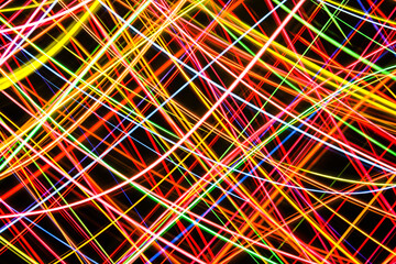 Wall Mural - Web of colorful lines. Neon lights texture. Colorful glowing lines backdrop. Illuminated mesh pattern. Grid of night light. Chaos glow effect. Party night background. Dancing lights motion.