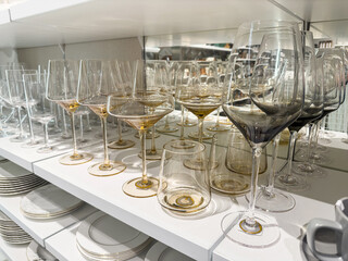 Various sizes of elegant yellow wine glasses on store shelf