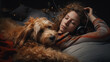 A woman with headphones lies on a bed with a dog. A girl rests with her dog and listens to music with headphones
