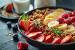 Bowl of baked granola and sliced fruits. Close up photo of muesli flakes with berries and cup of milk. Dieting food and healthy breakfast concept