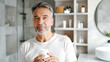 © ximich_natali - A mature man holds a jar of moisturizing cream in his hands, symbolizing skin care at any age, home bathroom background. Soft masculinity, daily self-care