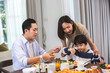 Asian lovely family having lunch or dinner at home dining table, enjoy eating party indoor house together. Attractive senior elderly grandparent and young daughter eat foods reunion celebrate weekend