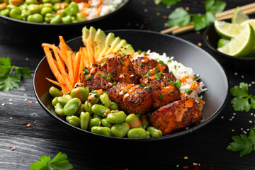 Wall Mural - Firecracker salmon poke bowl with edamame, avocado carrot and rice