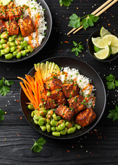 Wall Mural - Firecracker salmon poke bowl with edamame, avocado carrot and rice