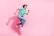 Full length profile photo of cheerful lovely person jump rush empty space isolated on pink color background