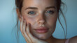 Portrait of young Caucasian woman, close up shot of velvety, soft and smooth facial skin with freckles