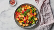 A bowl filled with cubes of tofu, broccoli florets, and sliced peppers, creating a colorful and nutritious meal