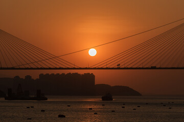 Wall Mural - Sunset on suspension bridge in Hong Kong city