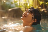 Fototapeta Londyn - happy beautiful young asian woman relaxing in hot spring pool in the morning
