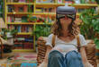 © Vadim - Young woman is sitting in chair in library wearing VR headset.