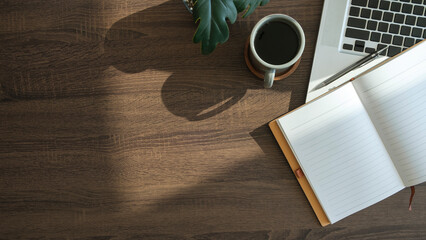 Wall Mural - Modern workplace with laptop computer, coffee cup and pencils on wooden background. Top view.