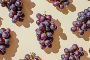Sticker - Bunches of fresh grapes arranged on a light colored surface with shadows, perfect for wine or fruit themed backgrounds