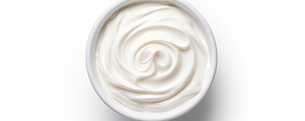 Wall Mural - Top view of isolated bowl of sour cream or Greek yogurt on white background