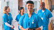 © Monkey Business - Portrait Of Smiling Multi Cultural Medical Team Wearing Scrubs In Modern Hospital