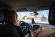 © Space Creator - Young woman driving inside car on crossway with navigation. Transportation, road on vacation concept