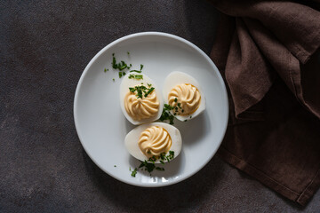 Wall Mural - Deviled eggs with fresh herbs, perfect Easter party appetizer, directly above