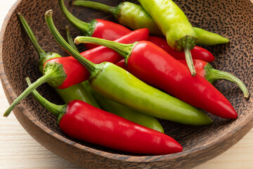 Wall Mural - Bowl with whole fresh raw green and red hot rawit peppers close up