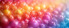 Abstract Background With Gradient Of Red To Yellow Droplets, Resembling Candies, With Sparkling Bokeh Effect.