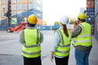 © offsuperphoto - back view workers or engineer using walkie talkie and showing gesture to crane car in containers warehouse storage