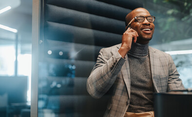 Wall Mural - Successful young businessman using smartphone in coworking space