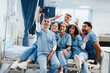 © Jacob Lund - Group of nursing and medical students taking a celebratory selfie in a hospital