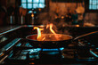 © Concept Photo Studio - Feu dans une poêle sur la cuisinière à gaz dans la cuisine