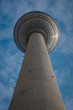 Tv tower in Berlin, on Alexanderplatz square on a clear spring day. Prominent tall building in Berlin, Germany. Looking directly up towards the ball restaurant.
