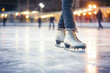Skaters gracefully maneuver on the ice, their sharp blades carving intricate figures as they enjoy the seasonal recreation.