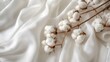 Elegant Cotton Bolls on White Fabric. Soft cotton bolls resting on delicate white cotton fabric, symbolizing natural fibers and purity.