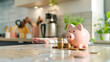Piggy Bank on the Kitchen Counter or Table with Money Coins in the Kitchen. Saving Money by Frugal Living Concept.