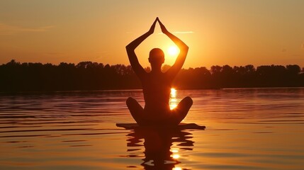 Poster - a person sitting on a surfboard in a body of water with their hands in the air as the sun sets.