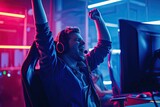Fototapeta Most - happy male cyber sport gamer raising hand, celebrating success participating in professional eSports tournament