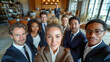 © Viorel Sima - work team selfie of men and women wearing elegant suits and smiling